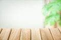 The surface of the wooden table isolated on blur leaves green background.