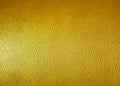 Surface of yellow leatherette texture as background