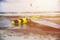 Surfboard on the beach, kitesurfing in the background Royalty Free Stock Photo