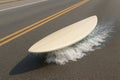 Surfboard floats on asphalt road with wave. Royalty Free Stock Photo