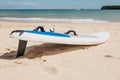 Surfboard lies on the sand on the beach