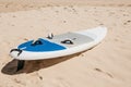 Surfboard lies on the sand on the beach