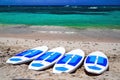 Surfboards abandoned on an empty sandy beach with waves in distance. Royalty Free Stock Photo