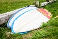 Surfboards stacked and leaned against wooden fence laying on ground. Royalty Free Stock Photo