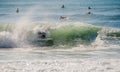 Surfer in a barrel falling under the force of the waves