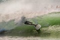 Surfer in a barrel falling under the force of the waves