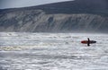 Surfer on the beach at Compton Bay Isle of Wight Royalty Free Stock Photo