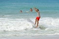 Surfer on the Beach Riding into a Wave