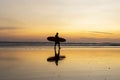 Surfer on the beach at sunset. Surf silhouette of man walking with surfboard Royalty Free Stock Photo