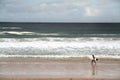 Surfer on a beach Royalty Free Stock Photo