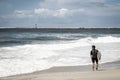 Surfer on beach with waves