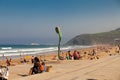 Surfer beach of Zarautz with people next to a sculpture 8