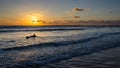 Surfer in a beautiful and colorful sunset at the Mediterranean Sea at the Charles Clore Beach, Tel Aviv, Israel