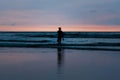 Surfer black silhouette at sunset