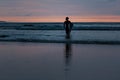 Surfer black silhouette at sunset