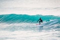 Surfer and blue waves. Winter surfing in ocean Royalty Free Stock Photo