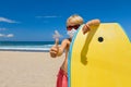 Surfer boy with bodyboard wearing protective masks on sea beach Royalty Free Stock Photo