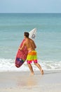 Surfer Carry Surfboard into the Ocean