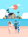 Surfer couple summer vacation man woman surf board on sunset beach villa house tropical island vertical flat