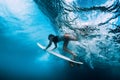 Surfer dive underwater. Surfgirl dive under wave