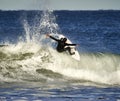 Surfer doing stunts with big waves in Carlsbad