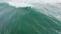 Surfer duckdiving through a wave