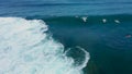 Surfer duckdiving through a wave