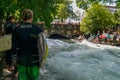 Surfer on the Eisbach in the English Garden with many spectactors