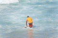 Surfer entering the sea to surf at Farol da Barra beach in the Brazilian city of Salvador Royalty Free Stock Photo