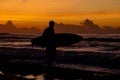 surfer entering water at the misty sunset Royalty Free Stock Photo
