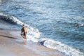 Surfer entering the water of Rio Vermelho beach in Salvador, Bahia Royalty Free Stock Photo