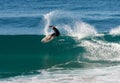 Surfer executing a frontside top-turn off-the-lip at Iluka.