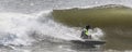 Surfer falling off of his surfboad into the wave Royalty Free Stock Photo