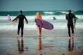 Surfer friends on a beach with a surfing boards Royalty Free Stock Photo