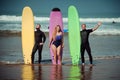 Surfer friends on a beach with a surfing boards Royalty Free Stock Photo