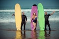 Surfer friends on a beach with a surfing boards Royalty Free Stock Photo