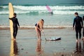 Surfer friends on a beach with a surfing boards Royalty Free Stock Photo