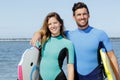 Surfer friends on beach with surfing boards Royalty Free Stock Photo