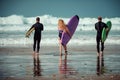 Surfer friends on a beach with a surfing boards Royalty Free Stock Photo