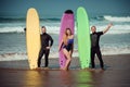 Surfer friends on a beach with a surfing boards Royalty Free Stock Photo