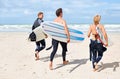 Surfer friends, running and back at beach with board, training or fitness on vacation in summer. Men, woman and Royalty Free Stock Photo