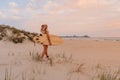 Surfer girl on beach with surfboard and sunset or sunrise. Attractive surfer women on beach Royalty Free Stock Photo