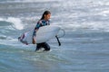Surfer girl carrying a short board Royalty Free Stock Photo