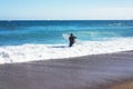 Surfer girl holding surfboard on background sea scape, sand beach coastline. Panorama horizon perspective view ocean, sunlight Royalty Free Stock Photo