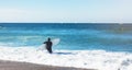 Surfer girl holding surfboard on background sea scape, sand beach coastline. Panorama horizon perspective view ocean, sunlight Royalty Free Stock Photo