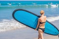 Surfer girl on the sandy beach. Surfer girl. Beautiful young woman at the beach. water sports. Healthy Active Lifestyle. Surfing. Royalty Free Stock Photo