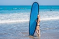 Surfer girl on the sandy beach. Surfer girl. Beautiful young woman at the beach. water sports. Healthy Active Lifestyle. Surfing. Royalty Free Stock Photo