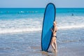 Surfer girl on the sandy beach. Surfer girl. Beautiful young woman at the beach. water sports. Healthy Active Lifestyle Royalty Free Stock Photo