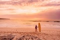 Surfer girl with surfboard at beach. Surfer woman with sunset or sunrise colors Royalty Free Stock Photo