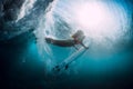 Surfer girl with surfboard dive underwater with under barrel ocean wave. Royalty Free Stock Photo